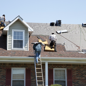 Roofing contractor working on homeowners roof.
