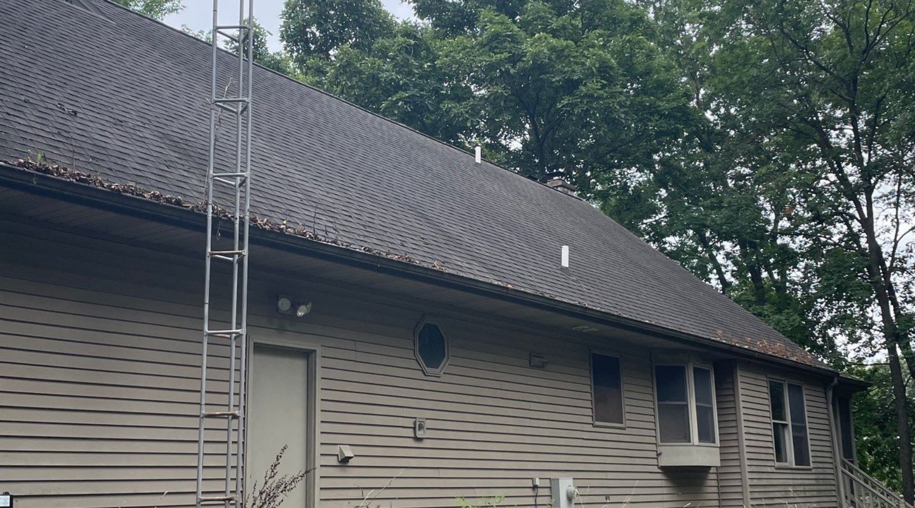 Professional roofing contractor installing a roof on a new construction home